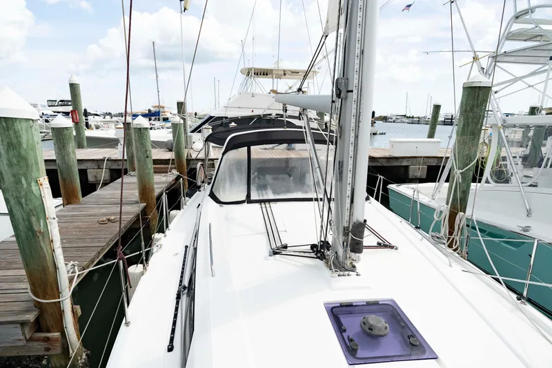 Slide: The Image of 2017 Beneteau Oceanis 41.1 sailboat docked at marina, surrounded by other boats. - 25