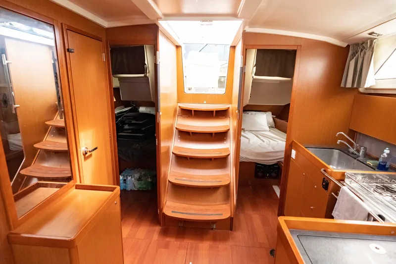 Slide: The Image of Interior of 2017 Beneteau Oceanis 41.1 yacht with wood finish and compact kitchen. - 28