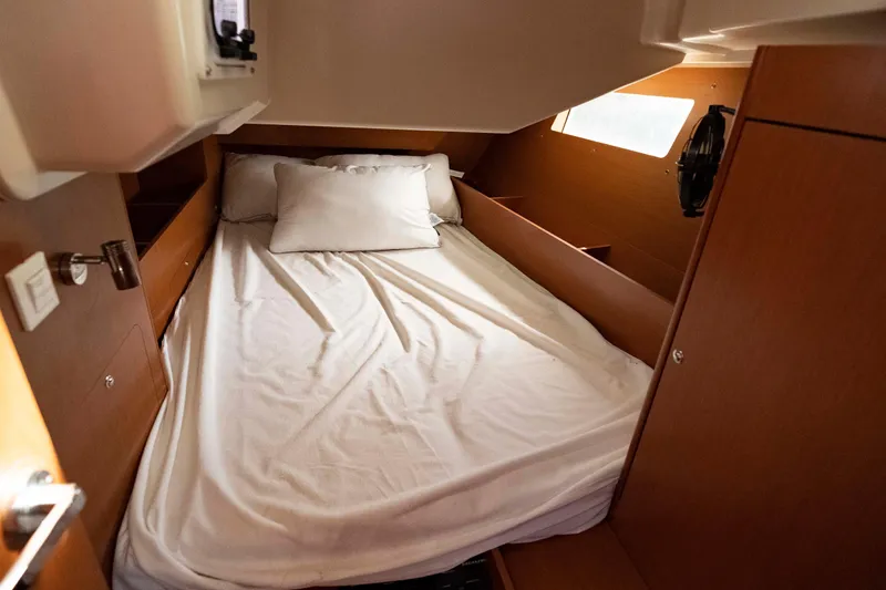Slide: The Image of Cozy cabin interior of 2017 Beneteau Oceanis 41.1 sailboat with bed and wooden finish. - 30
