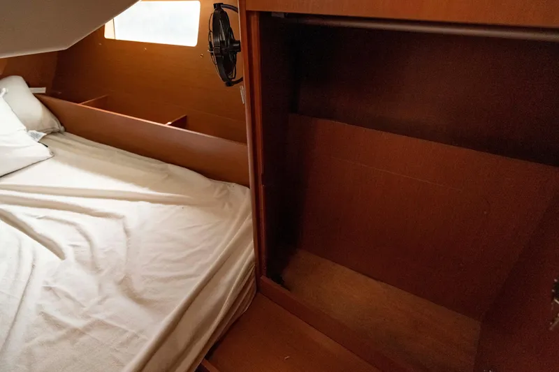Slide: The Image of Interior cabin of 2017 Beneteau Oceanis 41.1 yacht with bed and wooden storage. - 31