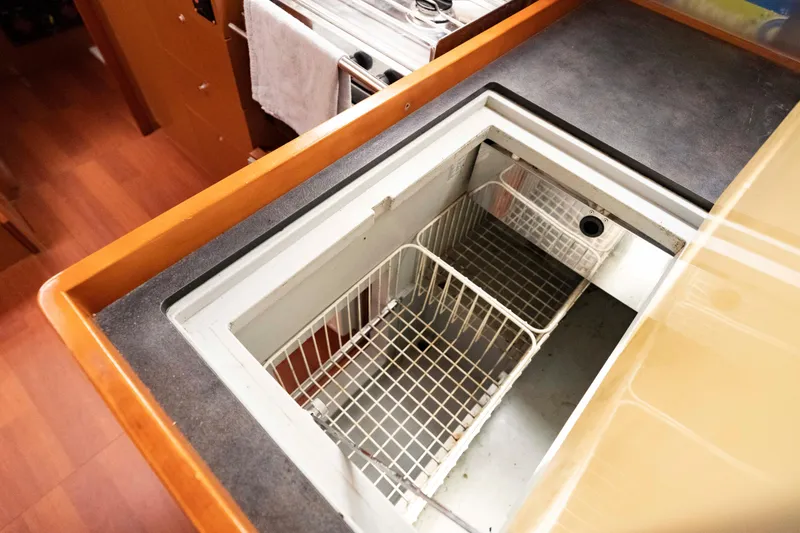 Slide: The Image of Interior view of 2017 Beneteau Oceanis 41.1 yacht kitchen with open fridge compartment. - 42