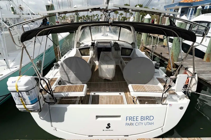 Slide: The Image of 2017 Beneteau Oceanis 41.1 sailboat docked, rear view with covered cockpit and seating. - 5