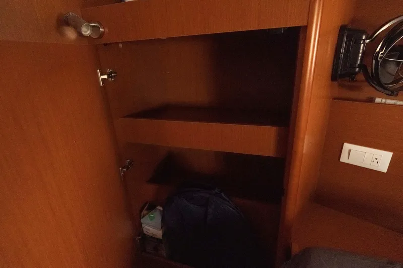 Slide: The Image of Interior storage cabinet on 2017 Beneteau Oceanis 41.1 yacht with wooden shelves. - 50