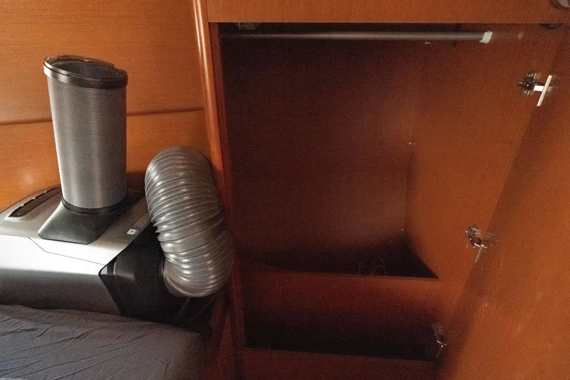 Slide: The Image of Interior of 2017 Beneteau Oceanis 41.1 yacht with air conditioning unit and open wooden cabinet. - 51