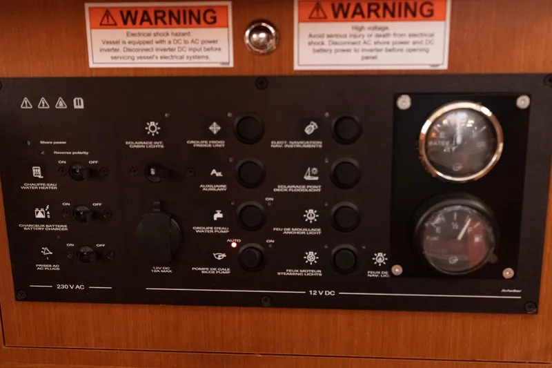 Slide: The Image of Electrical control panel on a 2017 Beneteau Oceanis 41.1 sailboat with warning labels. - 53