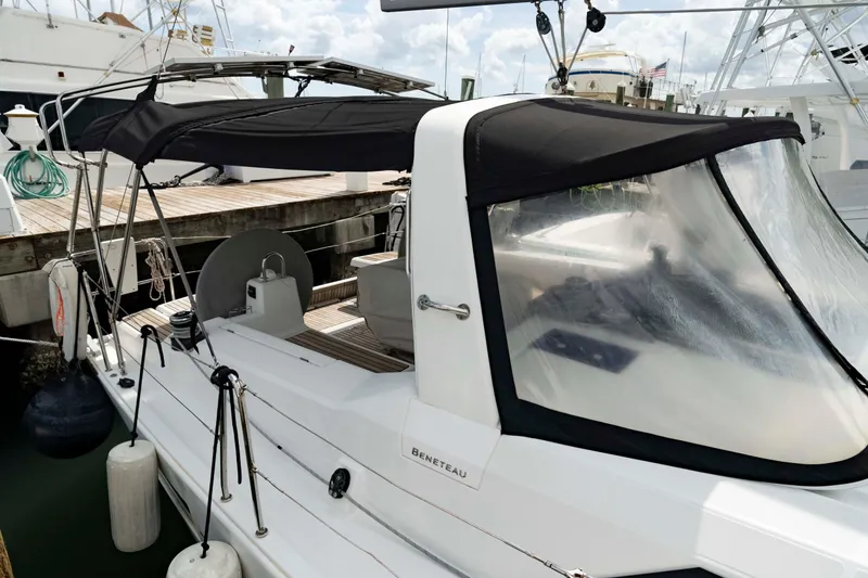 Slide: The Image of 2017 Beneteau Oceanis 41.1 sailboat docked, featuring a covered cockpit and sleek design. - 9