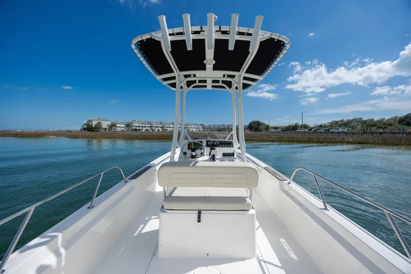 Slide: The Image of 2022 Boston Whaler 190 Montauk boat on calm water under clear blue sky. - 15