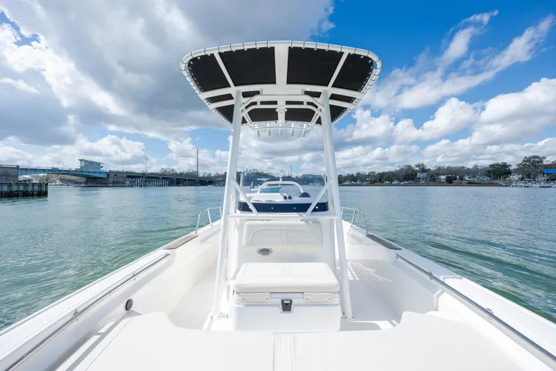Slide: The Image of 2022 Boston Whaler 190 Montauk boat on calm water under a partly cloudy sky. - 19