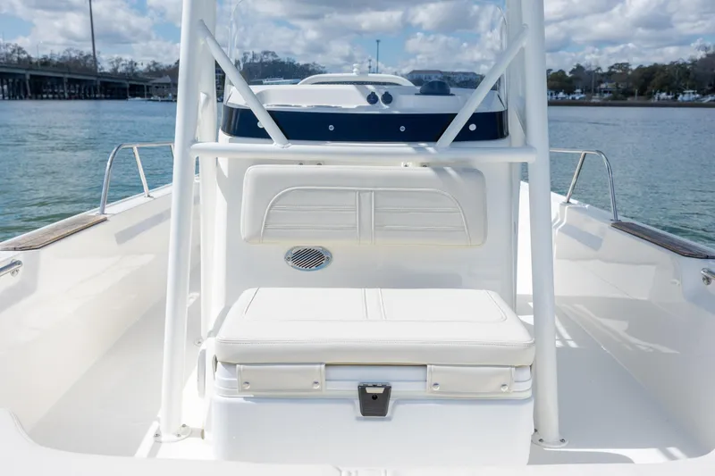 Slide: The Image of 2022 Boston Whaler 190 Montauk boat interior with seating and console on calm water. - 20