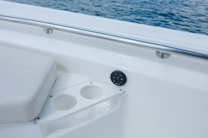 Slide: The Image of 2022 Boston Whaler 190 Montauk boat interior with cup holders and control panel. - 24