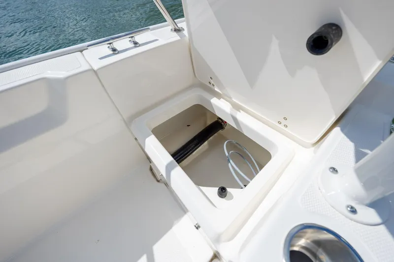 Slide: The Image of 2022 Boston Whaler 190 Montauk boat storage compartment open, showing interior details. - 25