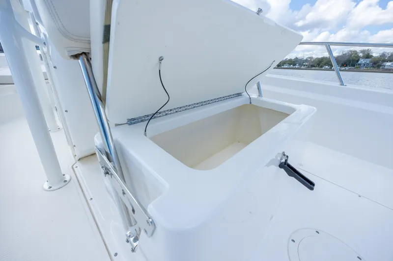 Slide: The Image of Open storage compartment on 2022 Boston Whaler 190 Montauk boat, with scenic water view. - 26