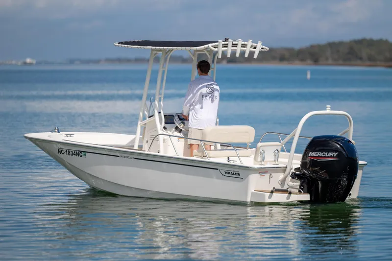 Slide: The Image of 2022 Boston Whaler 190 Montauk boat on calm water, featuring a Mercury outboard motor. - 7