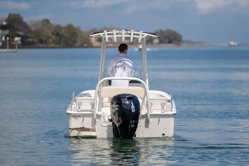 Slide: The Image of 2022 Boston Whaler 190 Montauk boat on calm water, rear view with Mercury engine. - 8