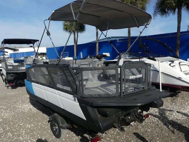 Slide: The Image of 2022 Sea-Doo Switch Cruise 18 boat with 100 hp, parked on gravel. - 6