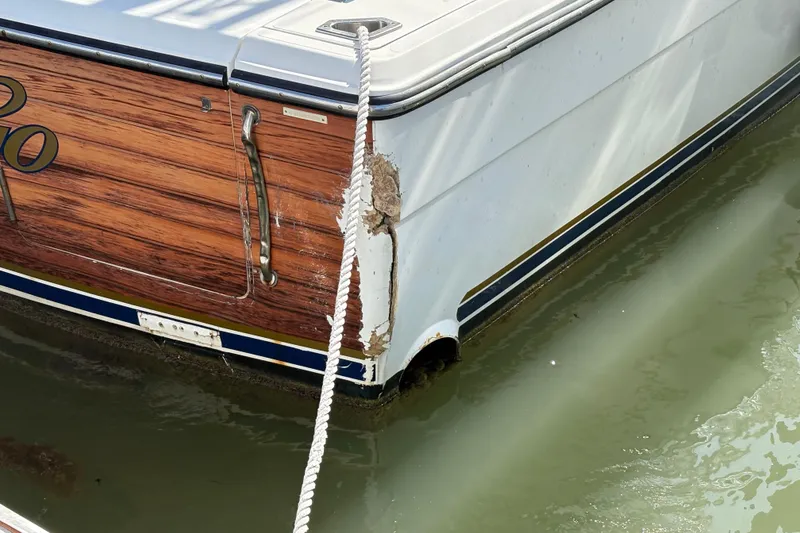 Slide: The Image of 2006 Rampage 38 Express boat with visible hull damage near waterline. - 10