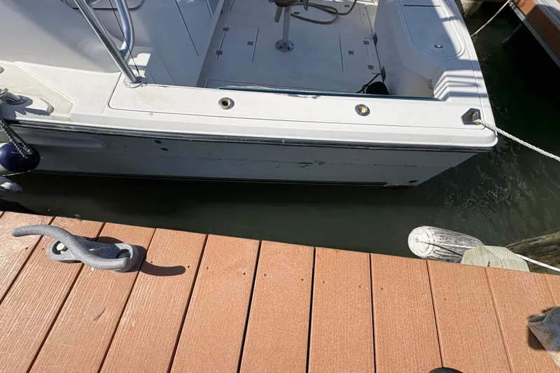 Slide: The Image of 2006 Rampage 38 Express boat docked at a wooden pier. - 11