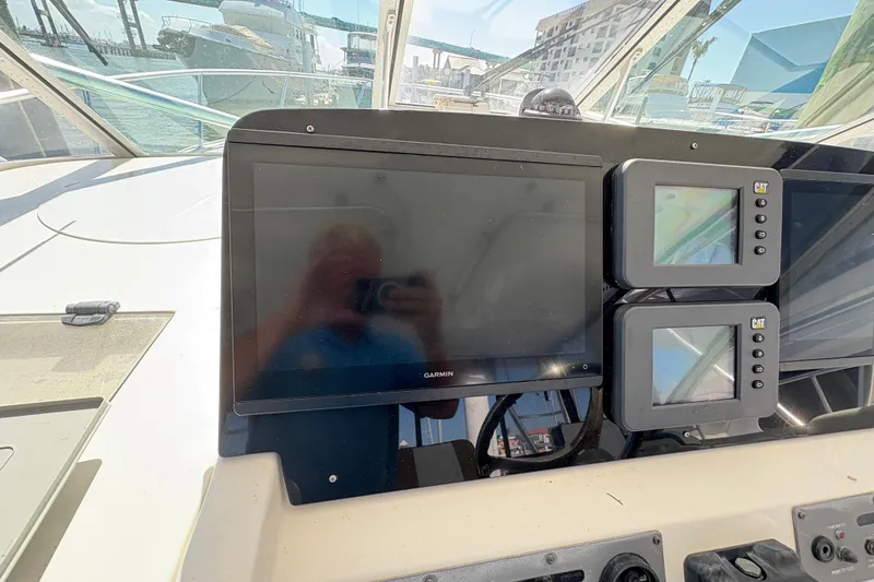 Slide: The Image of Control panel of a 2006 Rampage 38 Express boat with Garmin and CAT displays. - 24