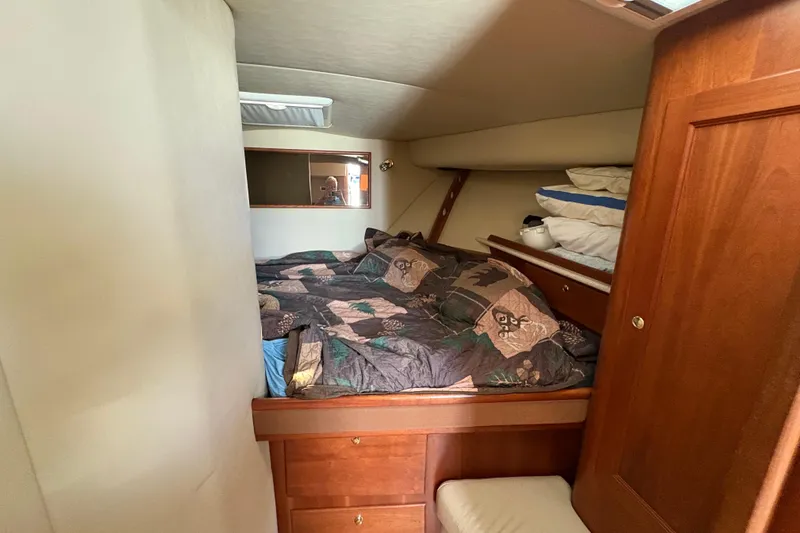 Slide: The Image of Cozy cabin interior of 2006 Rampage 38 Express with bed and wooden storage. - 28