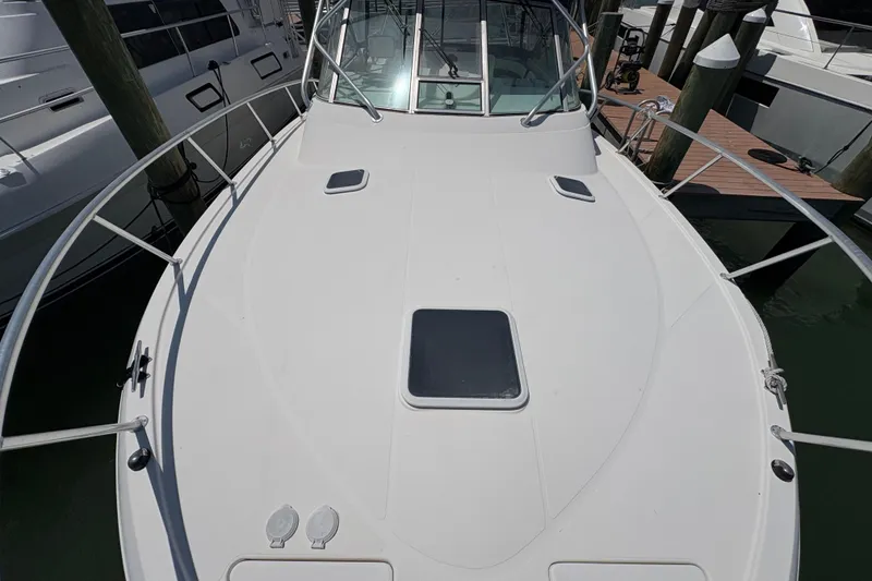 Slide: The Image of 2006 Rampage 38 Express boat deck with railing, docked at marina. - 7