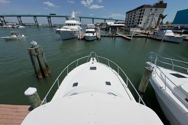 Slide: The Image of 2006 Rampage 38 Express yacht docked at marina with bridge and boats in background. - 9