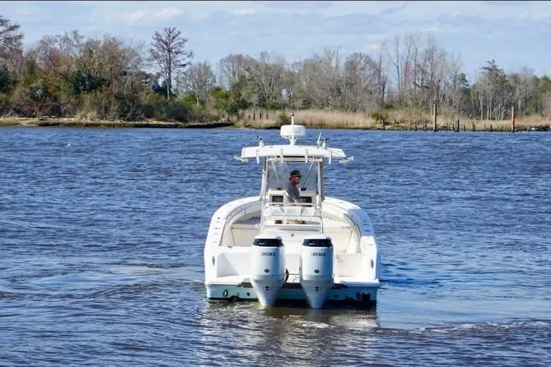 Slide: The Image of 2006 McKee Craft Freedom 28 FS/CC boat cruising on a scenic river. - 2