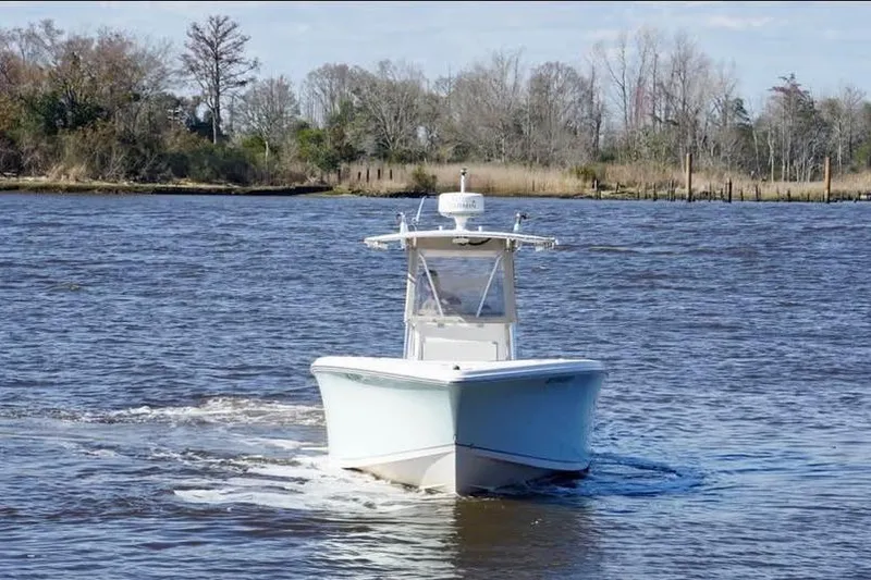 Slide: The Image of 2006 McKee Craft Freedom 28 FS/CC boat cruising on a river. - 4
