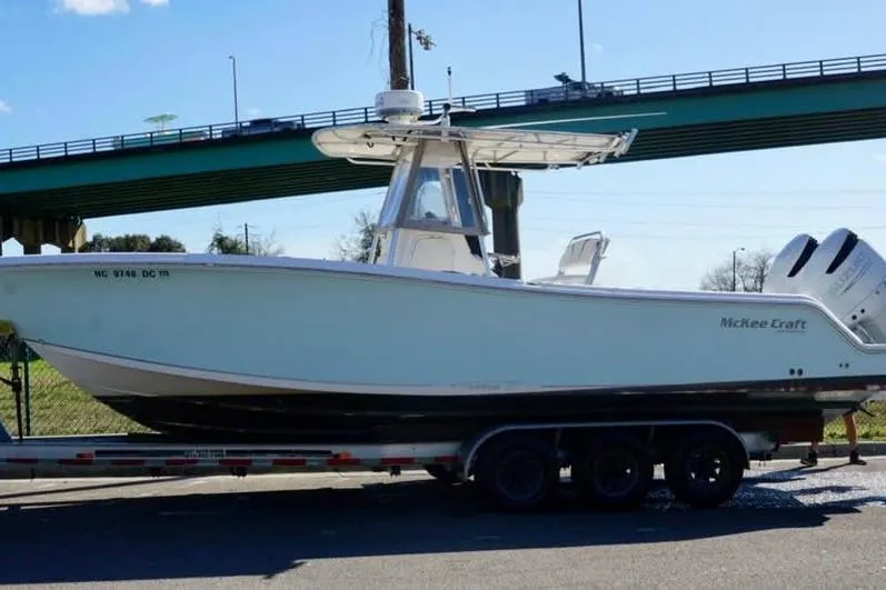 Slide: The Image of 2006 McKee Craft Freedom 28 FS/CC boat on trailer under bridge. - 5