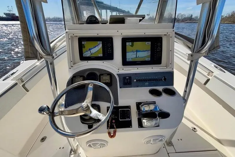 Slide: The Image of 2006 McKee Craft Freedom 28 FS/CC boat console with navigation screens and steering wheel. - 6