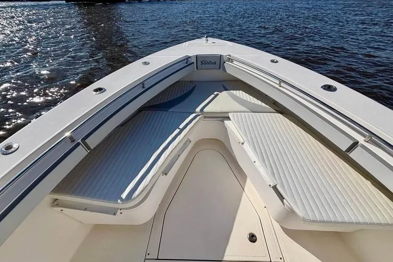 Slide: The Image of 2006 McKee Craft Freedom 28 FS/CC boat interior with cushioned seating, on calm water. - 9