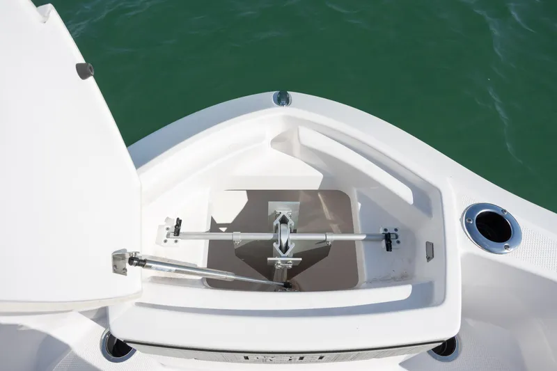 Slide: The Image of 2023 Yamaha Boats 255 FSH Sport E anchor compartment, open on calm water. - 13