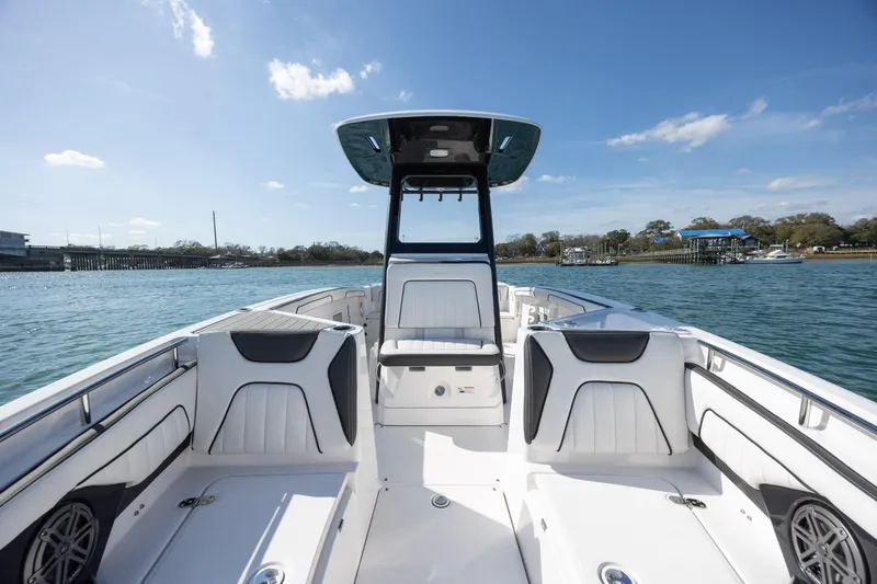 Slide: The Image of 2023 Yamaha Boats 255 FSH Sport E on water, showcasing sleek interior design. - 14