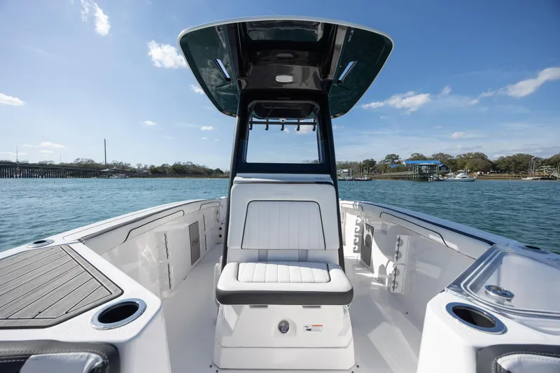 Slide: The Image of 2023 Yamaha Boats 255 FSH Sport E on water, showcasing sleek design and spacious seating. - 15