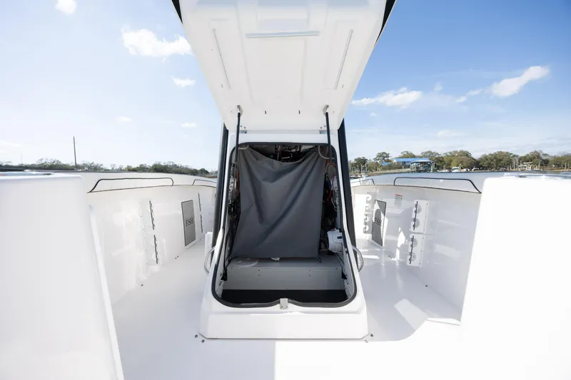 Slide: The Image of 2023 Yamaha Boats 255 FSH Sport E interior view with open storage compartment. - 16