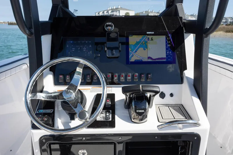Slide: The Image of 2023 Yamaha Boats 255 FSH Sport E dashboard with steering wheel and navigation display. - 20