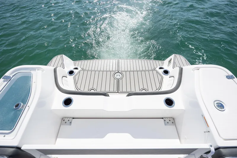 Slide: The Image of 2023 Yamaha Boats 255 FSH Sport E swim platform on water, showcasing sleek design. - 26