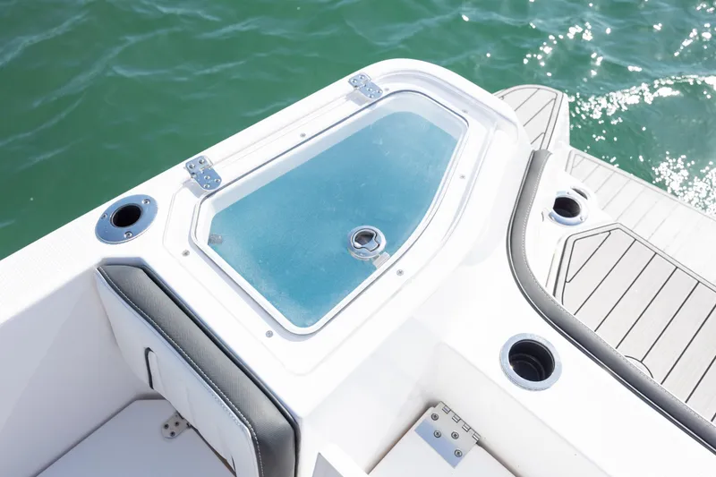 Slide: The Image of 2023 Yamaha Boats 255 FSH Sport E deck detail with livewell and rod holders. - 27