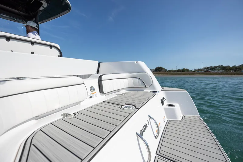 Slide: The Image of 2023 Yamaha Boats 255 FSH Sport E on water, showcasing sleek deck design. - 30