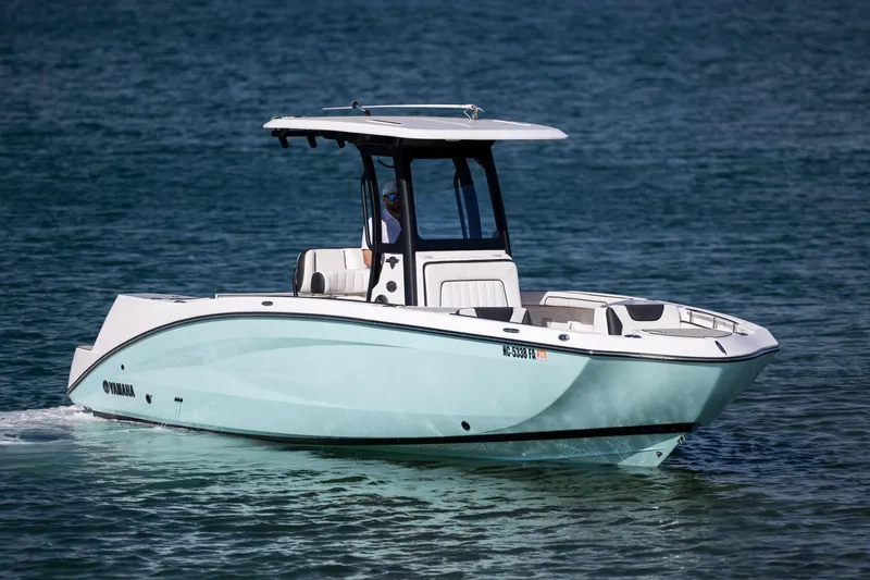 Slide: The Image of 2023 Yamaha Boats 255 FSH Sport E cruising on open water. - 6