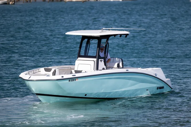 Slide: The Image of 2023 Yamaha Boats 255 FSH Sport E cruising on blue water. - 8