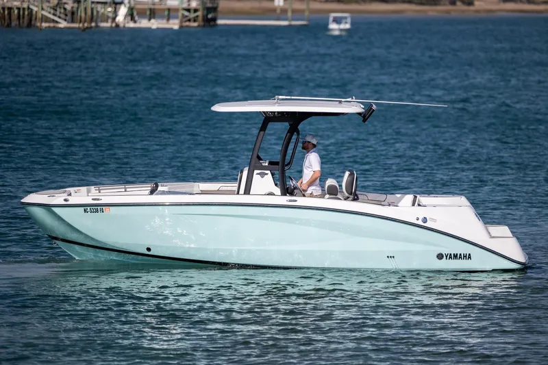 Slide: The Image of 2023 Yamaha Boats 255 FSH Sport E on calm blue water. - 9