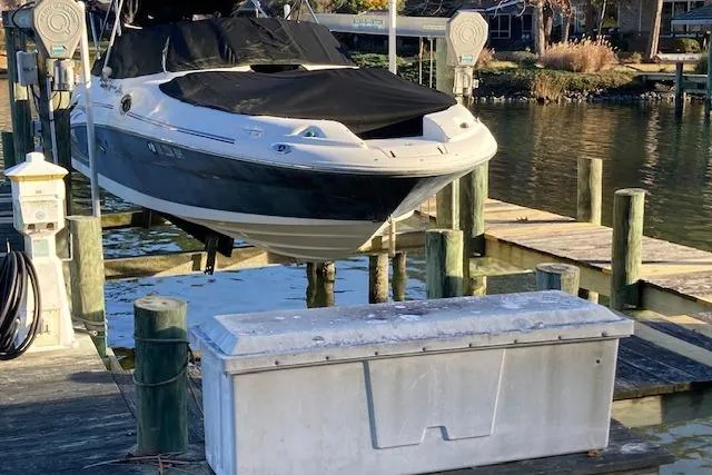 Slide: The Image of 2006 Sea Ray 270 Sundeck boat on lift at dockside, covered and ready for storage. - 10