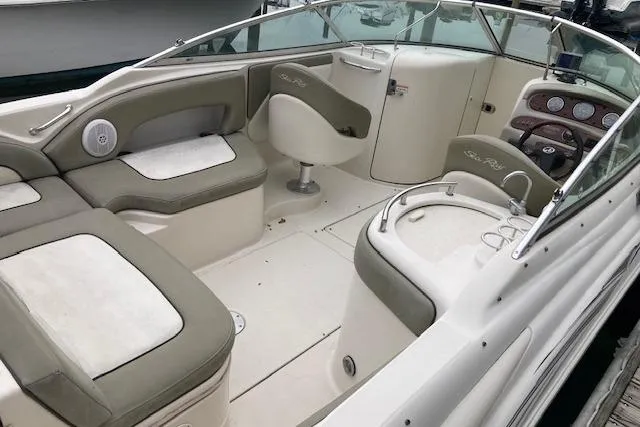 Slide: The Image of 2006 Sea Ray 270 Sundeck interior with seating, helm, and dashboard. - 2