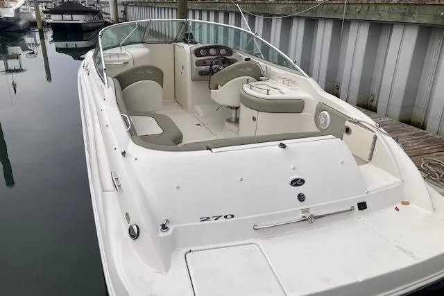 Slide: The Image of 2006 Sea Ray 270 Sundeck boat docked, featuring spacious seating and sleek design. - 3