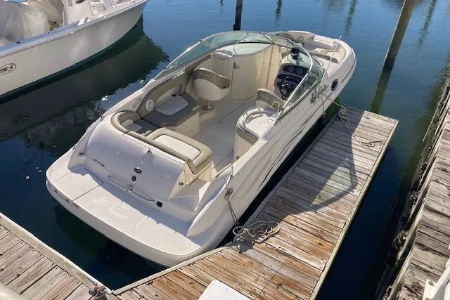 Slide: The Image of 2006 Sea Ray 270 Sundeck boat docked at marina, featuring spacious seating and sleek design. - 5