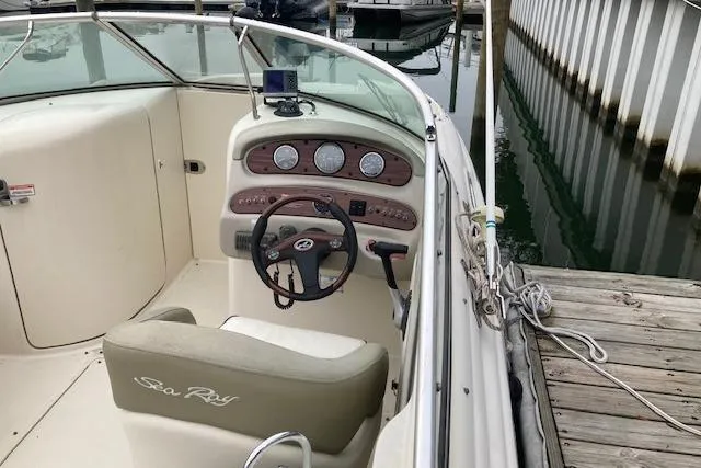 Slide: The Image of 2006 Sea Ray 270 Sundeck boat interior with steering wheel and dashboard at dock. - 7