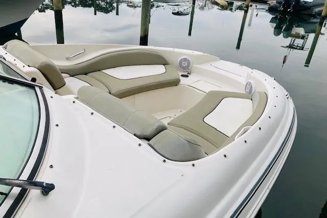 Slide: The Image of 2006 Sea Ray 270 Sundeck boat with spacious seating, docked on calm water. - 8
