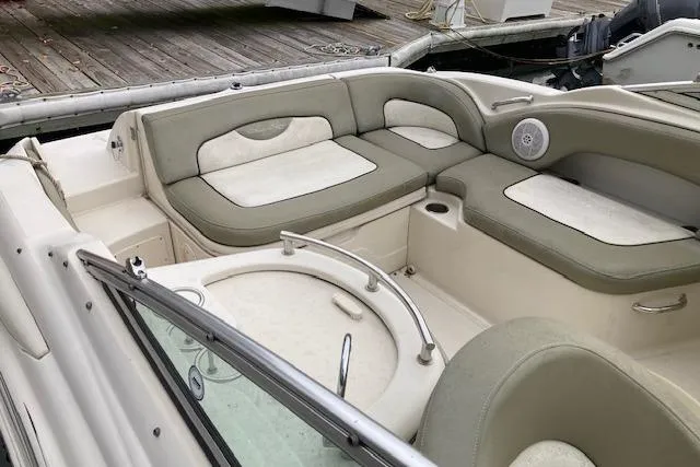 Slide: The Image of 2006 Sea Ray 270 Sundeck boat interior with cushioned seating and speaker. - 9