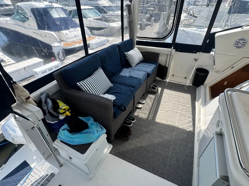 Slide: The Image of Interior of a 2000 Silverton 392 Motor Yacht with sofa and cushions. - 13