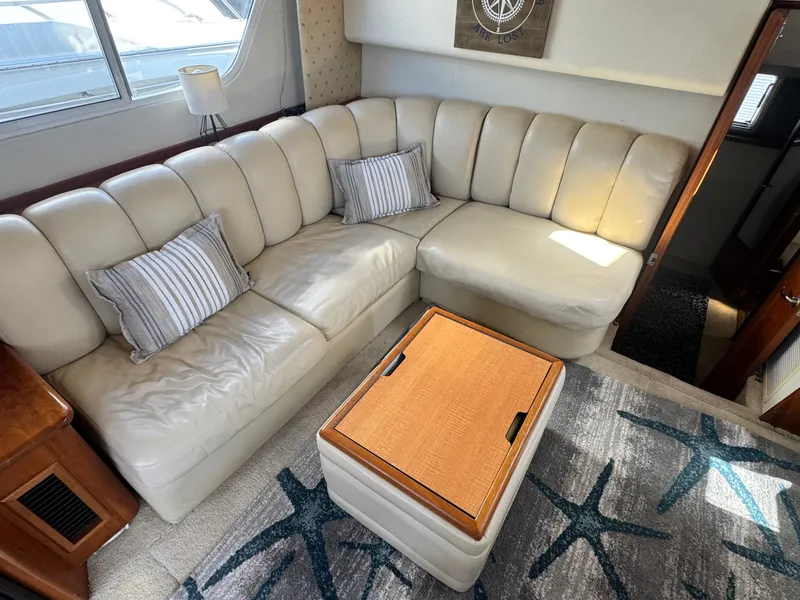 Slide: The Image of Interior of 2000 Silverton 392 Motor Yacht with leather sofa and cushions. - 14